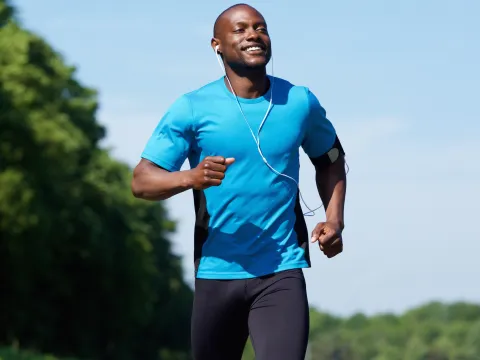 A man running outside while listening to music.