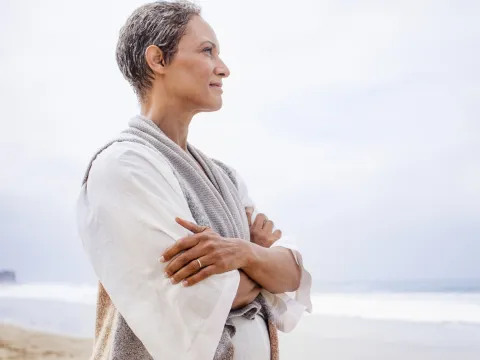 A woman standing on the beach.