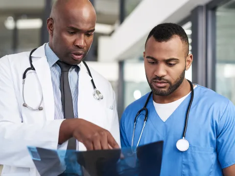 Two medical staff review an Xray.