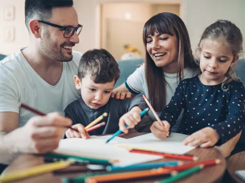 mom and dad playing with kids at home