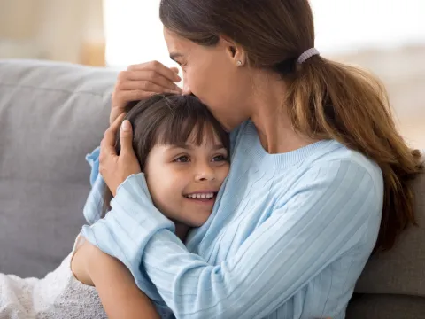 A mother hugs her child.