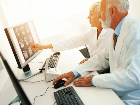 Two doctors look at an MRI scan