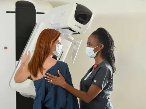 A woman being helped by her nurse for an x-ray