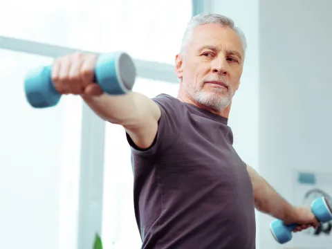 Man lifting weights at home.