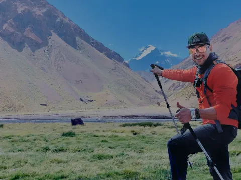 Man giving a thumbs up during a mountain climbing hike