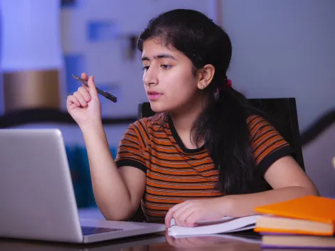 A teenager using her computer.