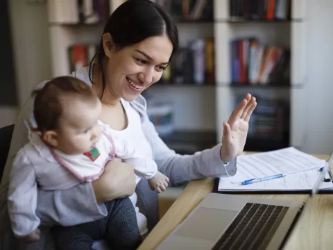 A mom and her baby have a video visit with a pediatrician. 