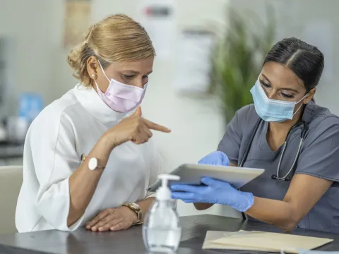 A woman discussing her health with her doctor. 