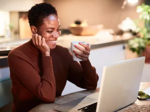 A woman reading on her computer.