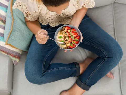A woman eating a plant-based meal