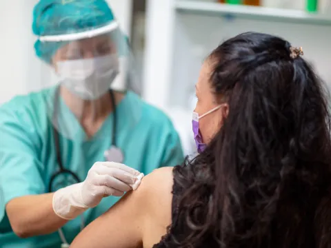 A woman getting her annual flu shot. 