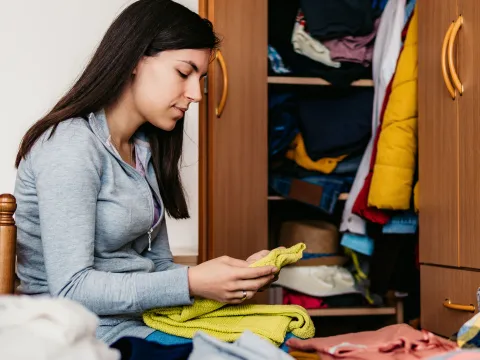 a woman donates her clothing