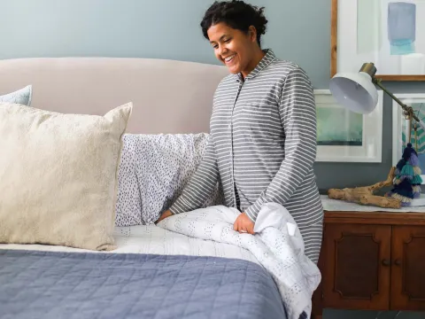 Woman making bed