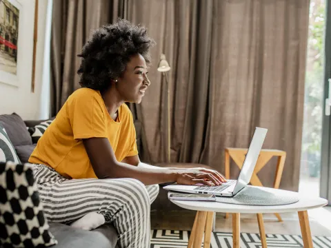 A woman on her laptop at her house