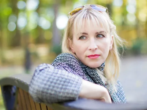 A woman sitting on a park bench as something catches her eye