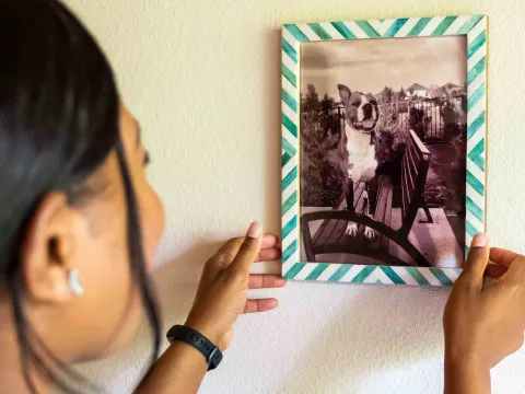 woman handing picture of dog