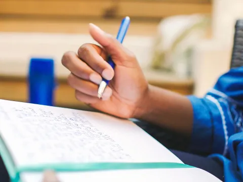 Woman writing in notebook