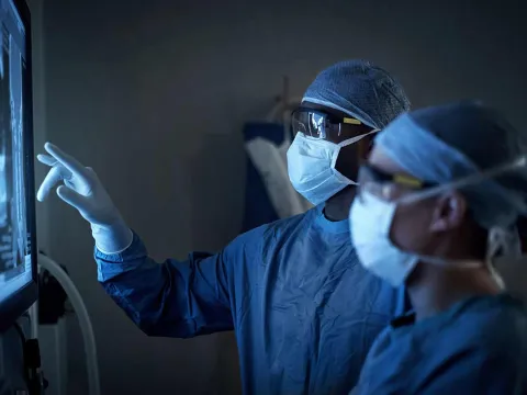 Doctors with masks looking at X-Ray