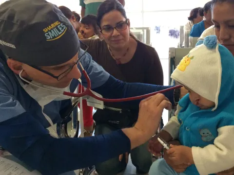 A doctor examines a child