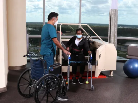 A Physical Therapist Helps a Patient During a Session.