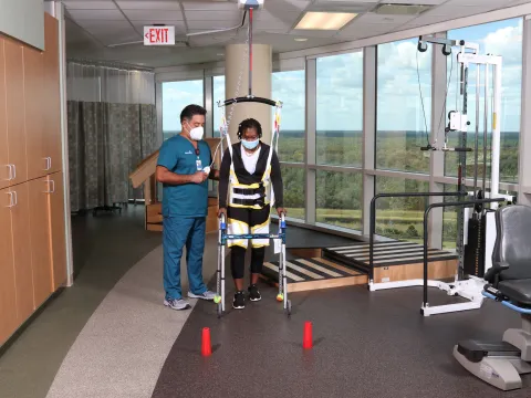 A Physical Therapist Helps a Patient During a Session.