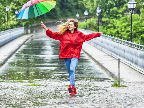 A woman dances in the rain.