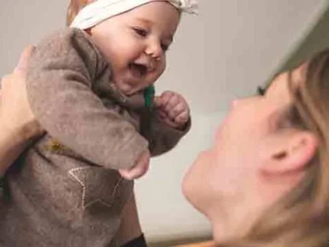 mom-lifts-up-baby-laughing