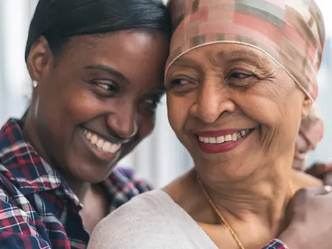 Mother and adult daughter embracing