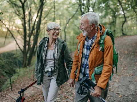 couple walks through the woods with healthy lungs