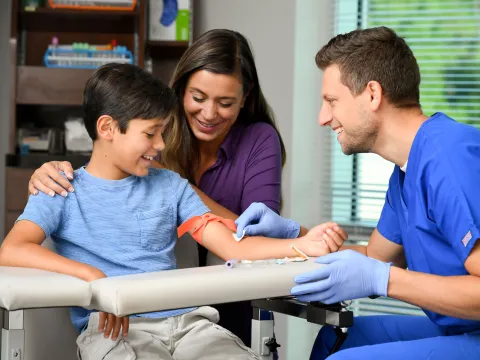 Male lab technician treating a young patient