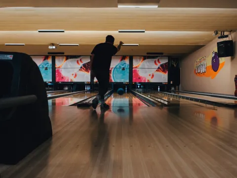 Man bowling at a bowling alley.