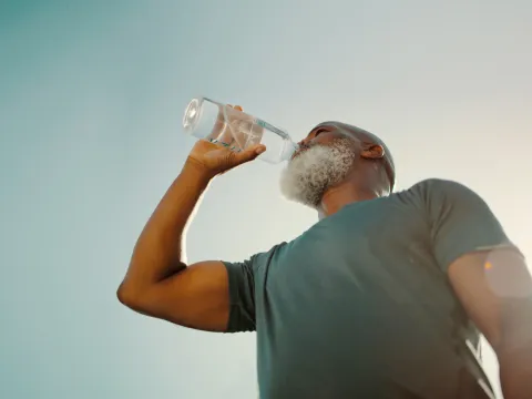 Man drinking water from a bottle.