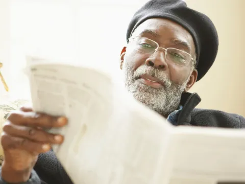 Man reading a newspaper.