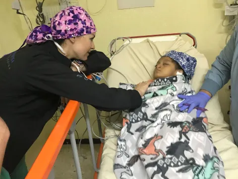 a doctor checks on a child