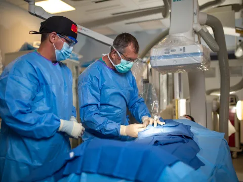 Neuro physicians performing Bi-plane procedure.