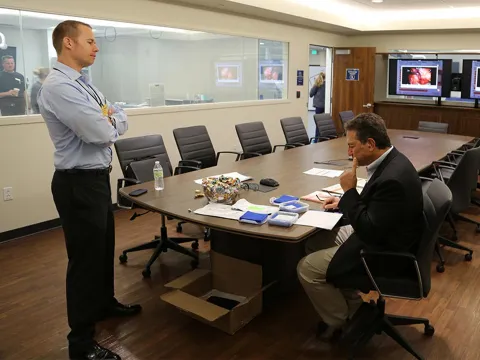 Two people working in a Nicholson Center Lab Boardroom.