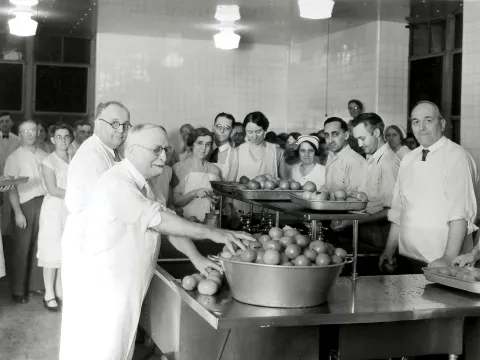 John Harvey Kellogg and staff in a kitchen.