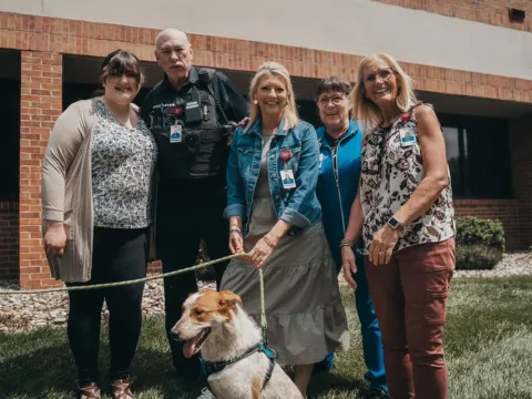 ottawa leadership posing with rescue dog