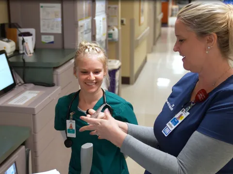 A preceptor nurse at AdventHealth Palm Coast mentors a student-nurse from Jacksonville University.