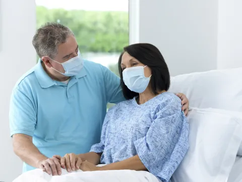 Patient with Family visitor in hospital bed