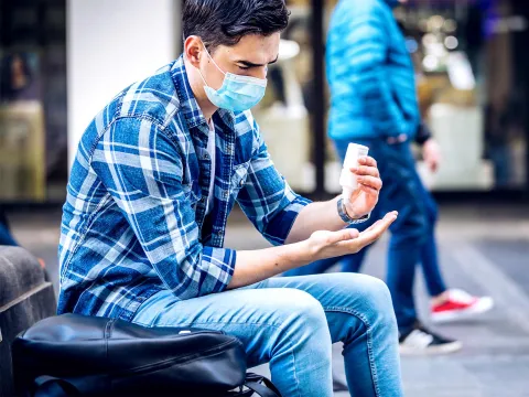 Person using hand sanitizer.