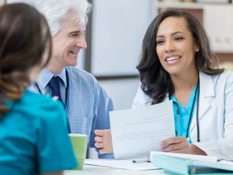 Two physicians interviewing job candidate