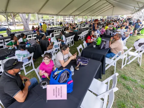 People under a banquet tent at the 2025 transplant reunion picnic