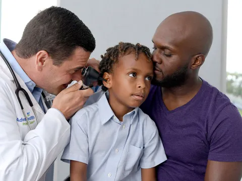 Provider checking child's ear