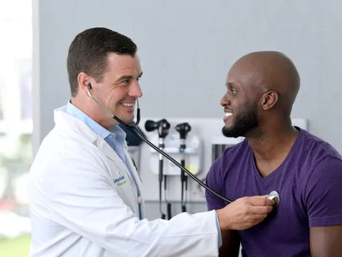 Provider with patient checking heartbeat