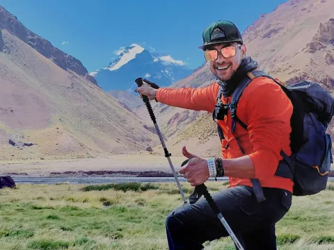 Man standing at the base of a mountain