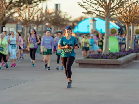 Woman running runDisney Princess 10k runner at Epcot.