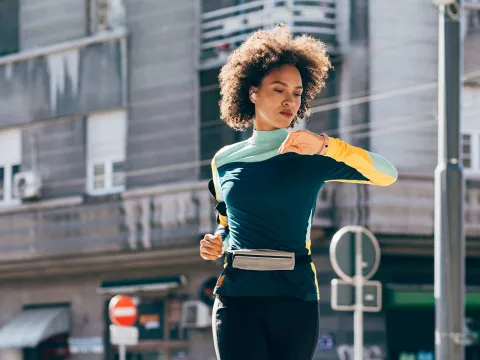 Young black woman running outside