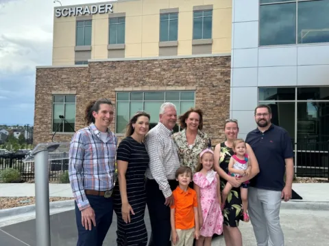 Schrader Family standing in front of the Schrader Building at AdventHealth Castle Rock