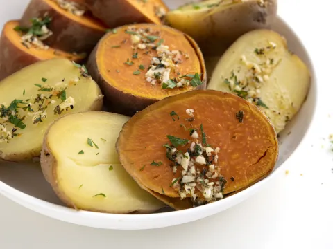 White bowl filled with cooked russet and sweet potatoes